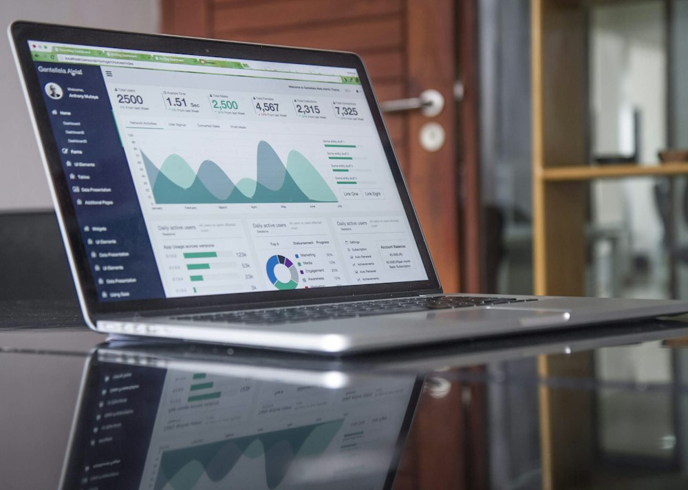 Laptop displaying financial reports and charts